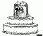 La impressionante torta nuziale decorata con figurine della sposa e lo sposo